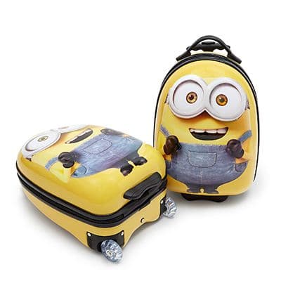 Two yellow hard-shell Minions suitcases with character faces and blue dungaree artwork, shown upright and lying on four wheels.