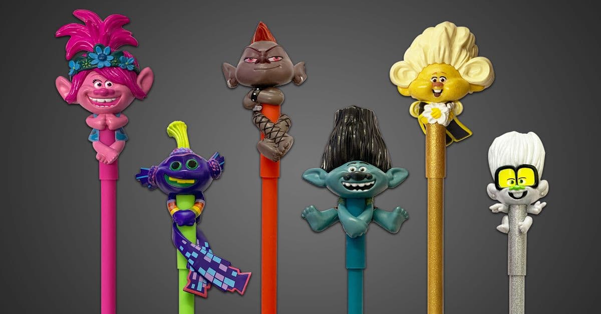 Six colourful Trolls character pens with sculpted toppers in pink, purple, orange, blue, gold and silver designs.