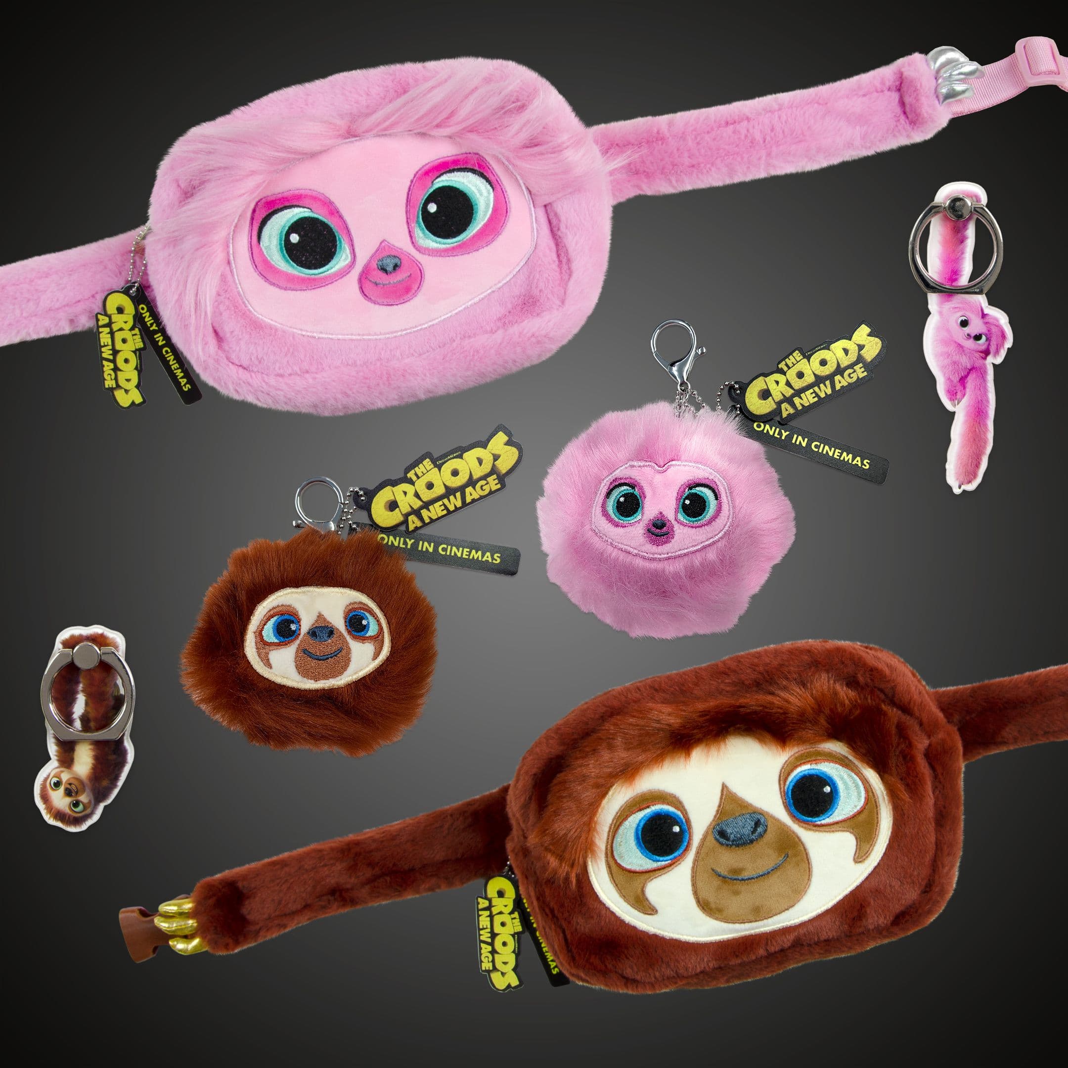 Pink and brown sloth-themed plush accessories from The Croods: A New Age, including belt bags, pom-pom keyrings and character phone ring holders.
