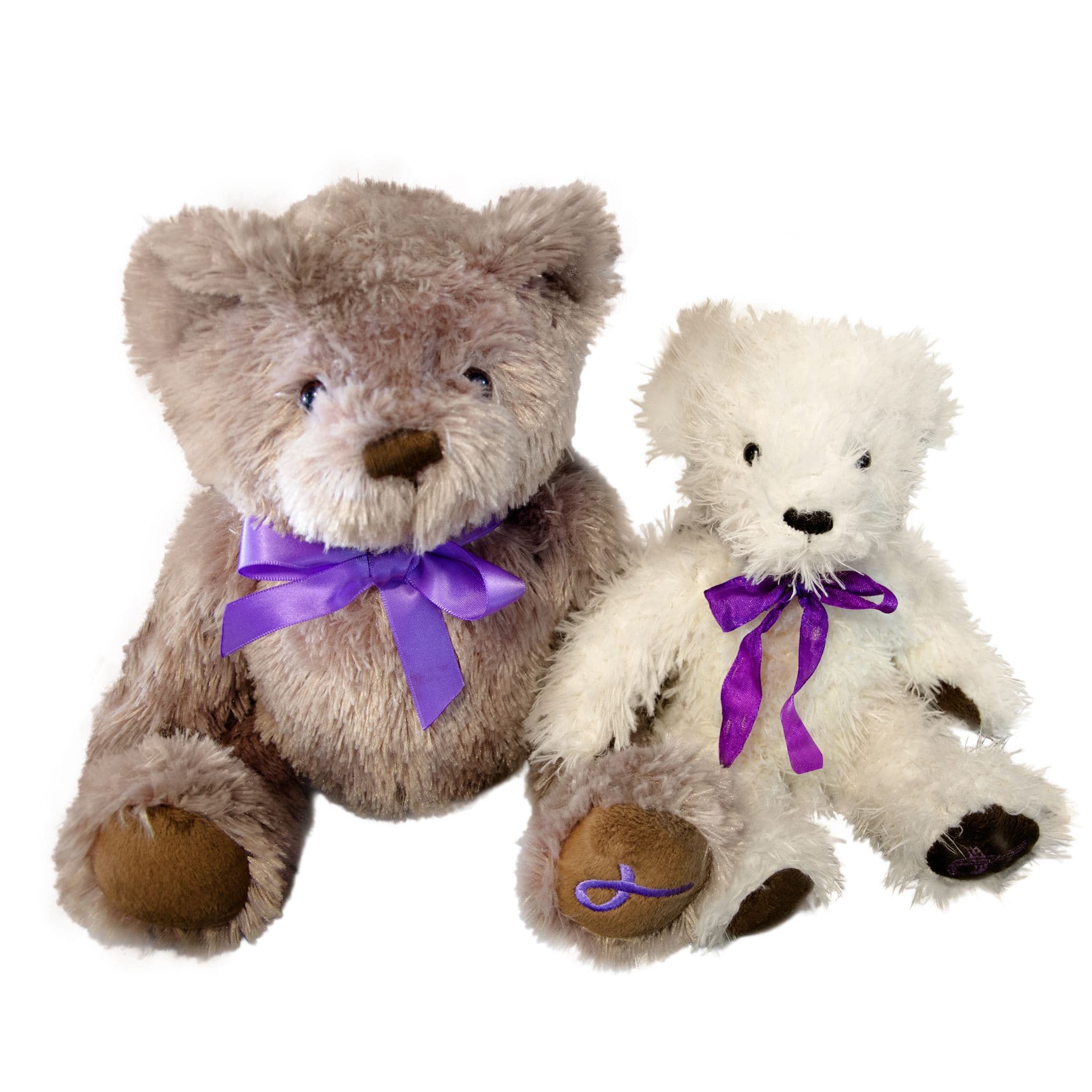 Two soft teddy bears, one grey and one white, wearing purple ribbon bows; the larger bear has an embroidered purple ribbon symbol on its paw.