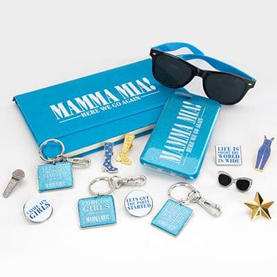 Turquoise Mamma Mia! accessories including a notebook, sunglasses, luggage tag, keyrings and small enamel pins.