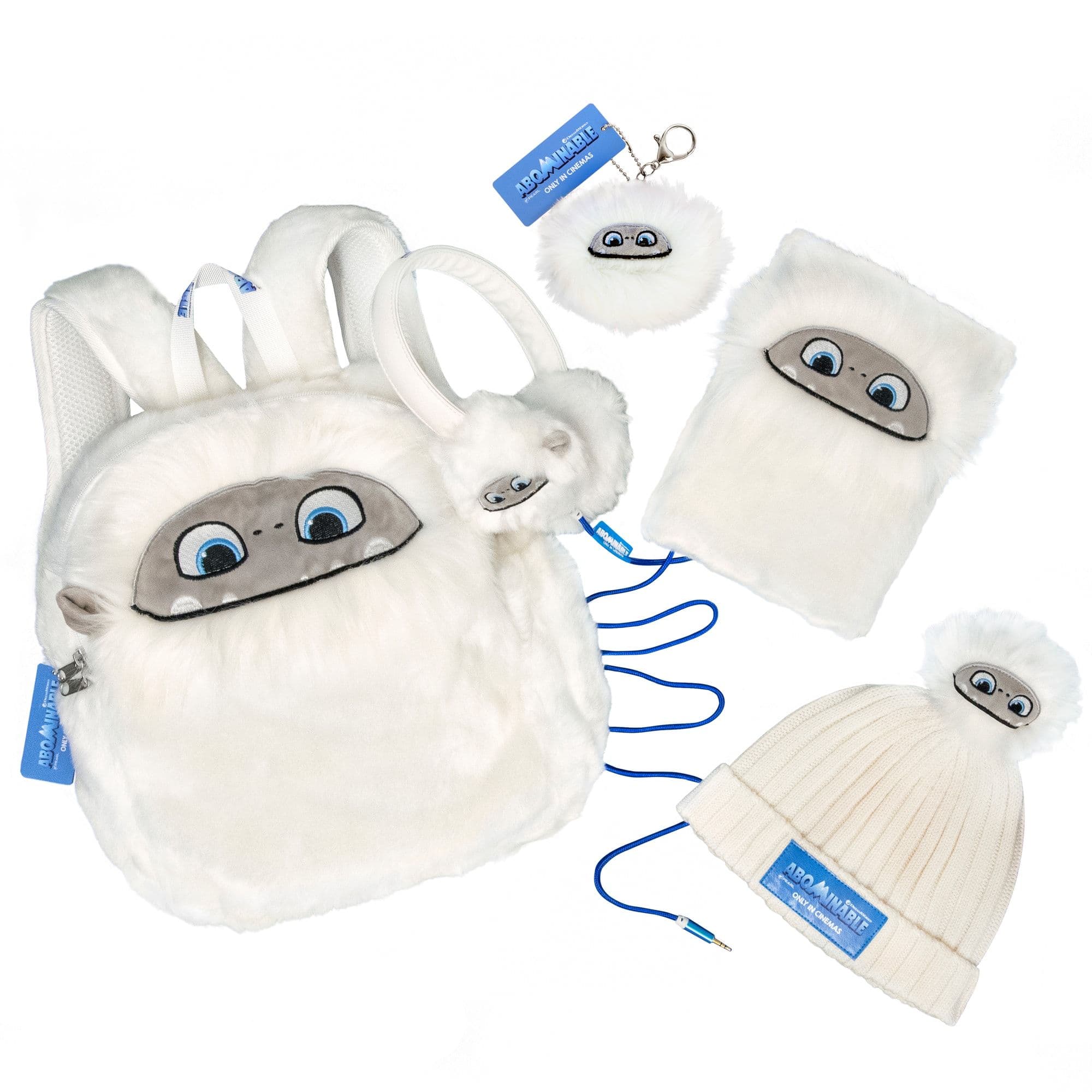 Abominable movie merchandise produced by TCS: a plush yeti backpack, headphones, keyring, notebook and bobble hat